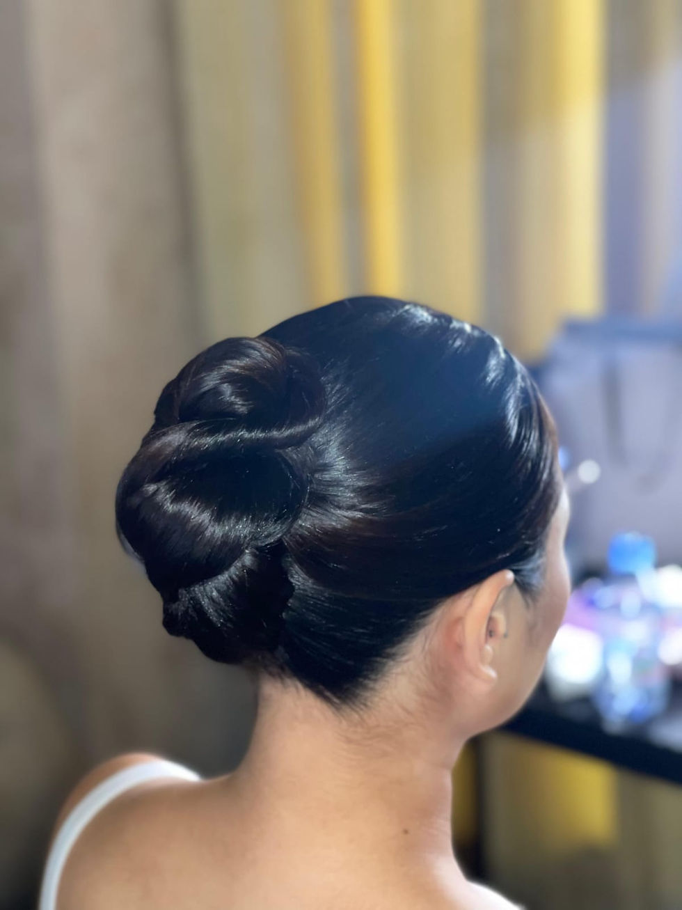 Sleek dark hair styled in an elegant updo