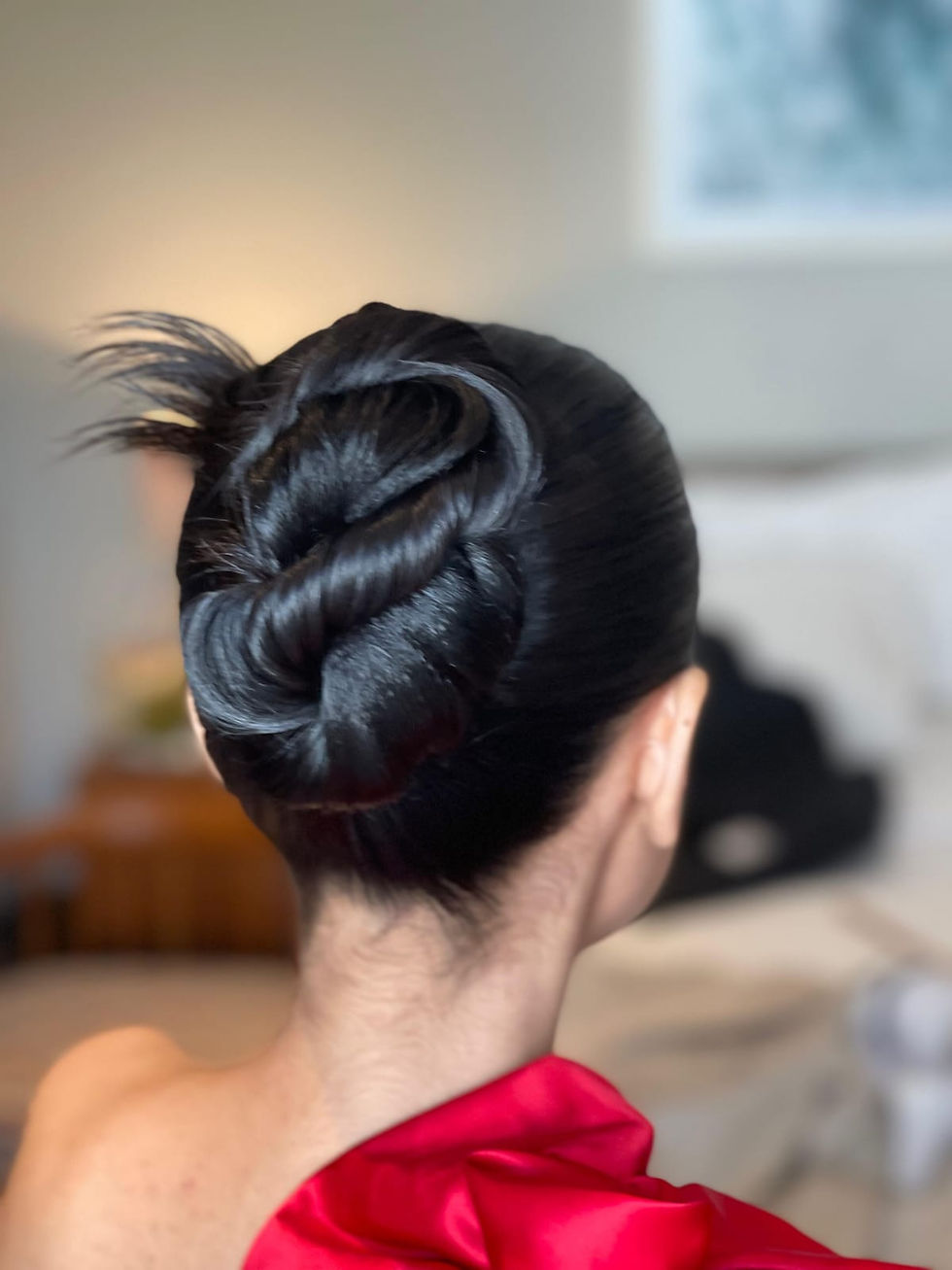 Sleek dark hair styled into a bun