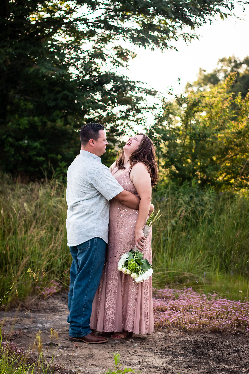 Cute couple share a laugh in a field in Lewisburg, Tennessee