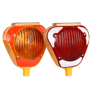 Two solar-powered warning signals, one orange and one red, designed to flash intermittently to alert drivers or pedestrians.