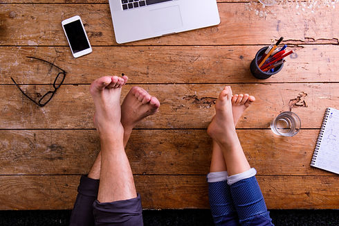 legs-of-father-and-son-office-desk-with-laptop-smart-phone-and-various-office-stuff-ar-SBI