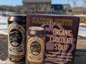 Samuel Smith’s Organic Chocolate Stout 4-pack and individual can featuring the classic brewery crest and cocoa pod illustrations."