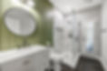 After renovation, the Jacksonville Golf & Country Club guest bathroom designed by Zen Reno & Design with an olive green paneled accent wall, round black mirror, white vanity, marble look shower tile, and dark hexagon flooring.