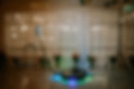 A 360-degree photo booth setup with LED lights and a rotating platform, surrounded by flor