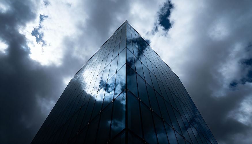 modern-glass-skyscraper-reflecting-dramatic-cloudy-sky.jpg
