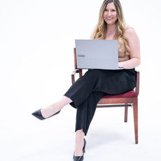 Alexandria sitting down and working on computer