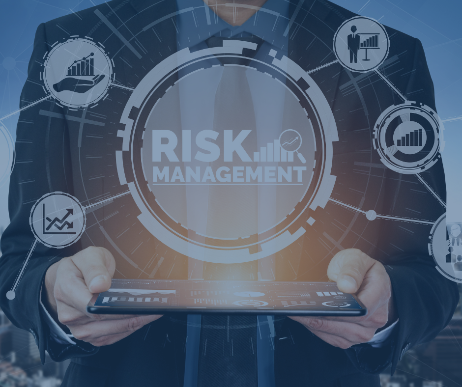 Businessman holding tablet with holographic RISK MANAGEMENT dashboard, finance icons, blue tech background.