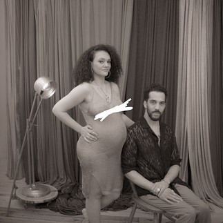 A monochrome image of a black woman sand a black man during a maternity photoshoot by pregnancy photographer HeardinLondon