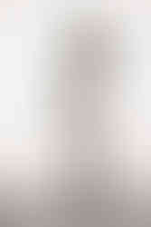 A monochrome image of a black woman in a hat and polka dot playsuit and black heels. It is a portrait photograph taken by body confidence photographer HeardinLondon