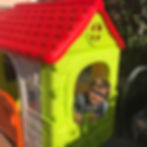 Child looking out of a playhouse window