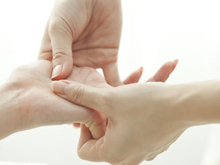 Close-up showing a hand being mobilized/massaged to treat the pinky and knuckles, restoring joint alignment.