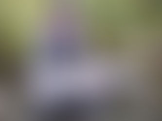 Brian Lansing holding a striped bass caught fly fishing on Cape Cod