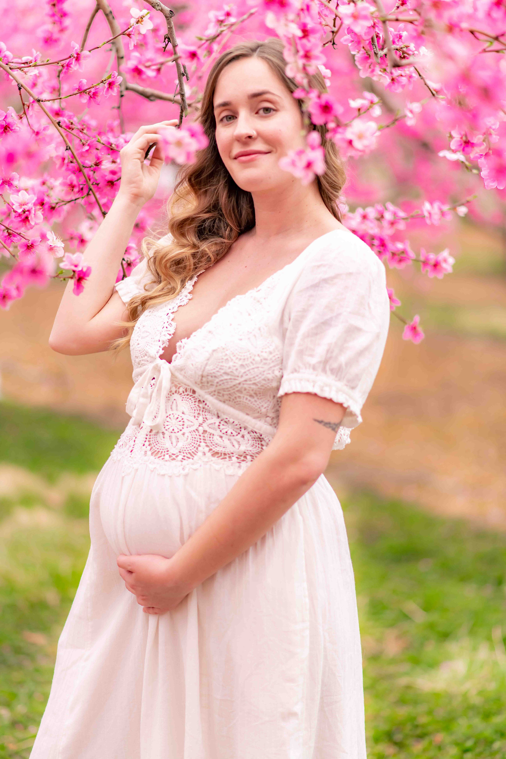 Maternity Photography in the peach blossoms at Orr's Farm Market in West Virginia by Virginia Matern