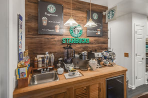 Starbucks Branded coffee bar with coffee machine and syrups.