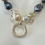 Thumbnail: Peacock and white Baroque Pearls with Sterling Silver rings pendant necklace. 