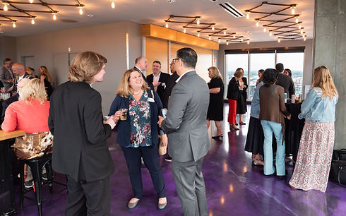 Group of people with drinks at a corporate event at Bar Moxy