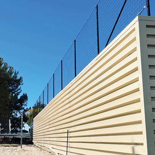 Netting Fence added to Stop Volleyballs from Flying Into This Secure Commercial Business.