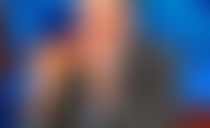 A picture of Jon Stewart eating a slice of pizza.