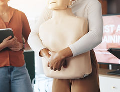 First aid, training and hands with choking dummy for CPR, abdominal thrusts and life savin