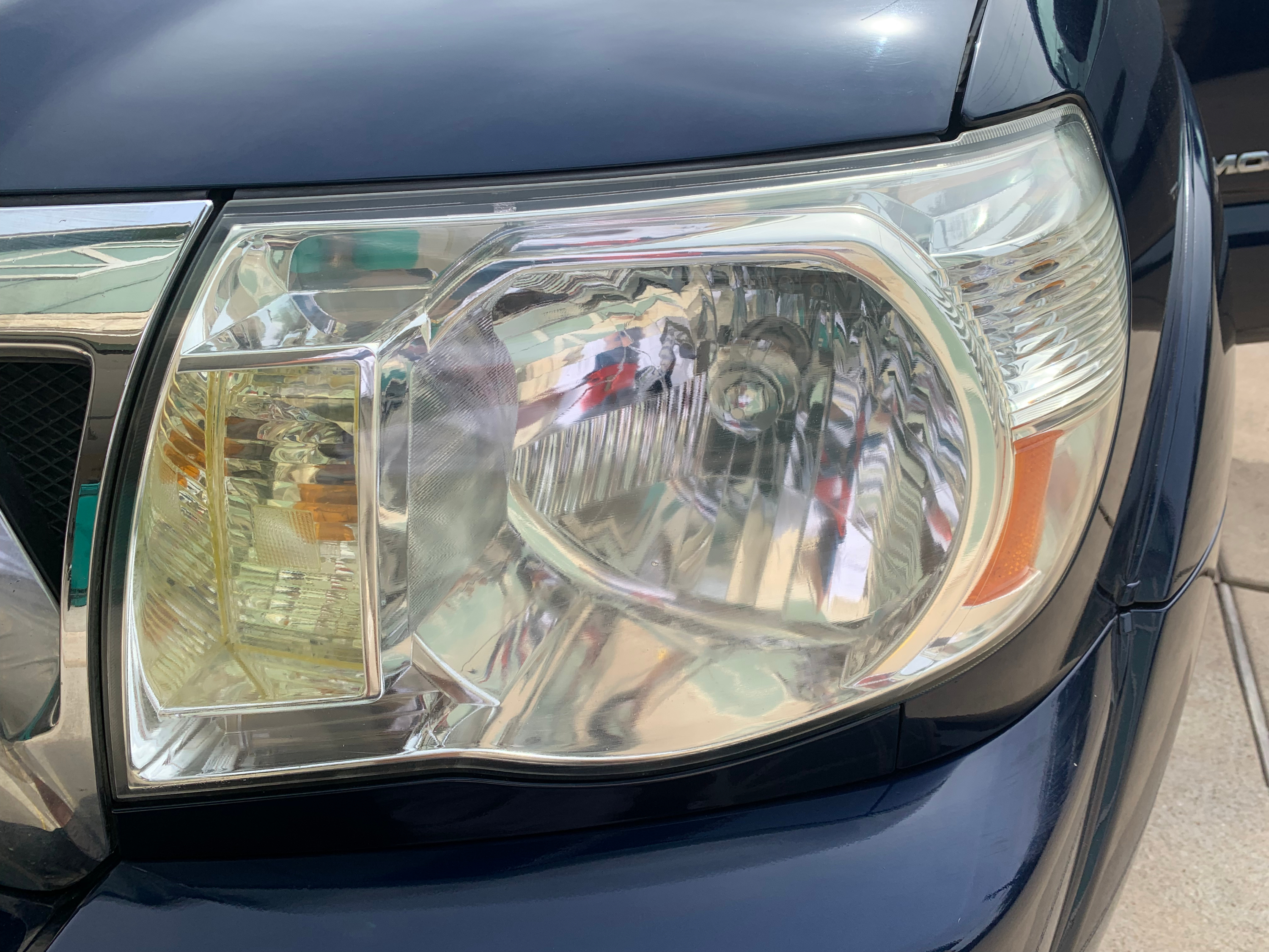 The same headlight lens after restoration, clear and polished