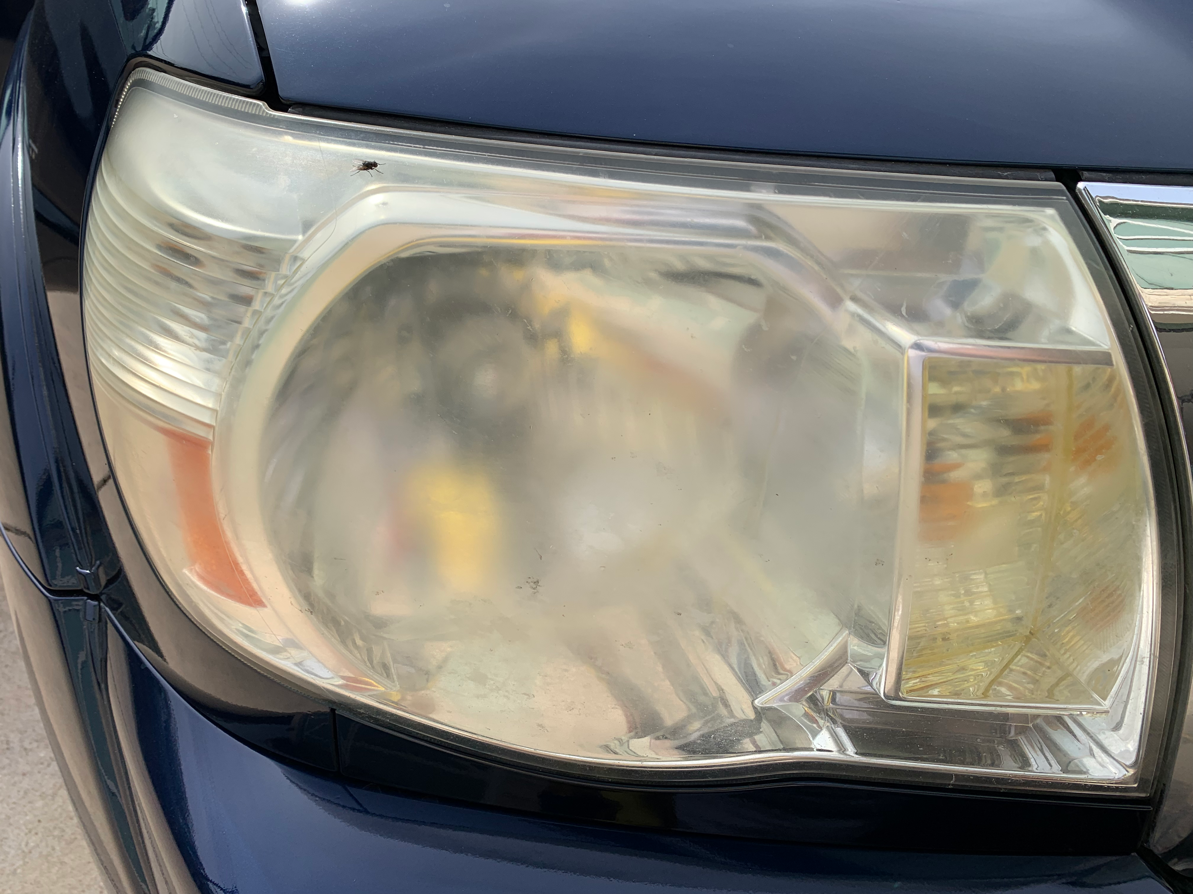 Clouded, yellowed headlight lens before restoration