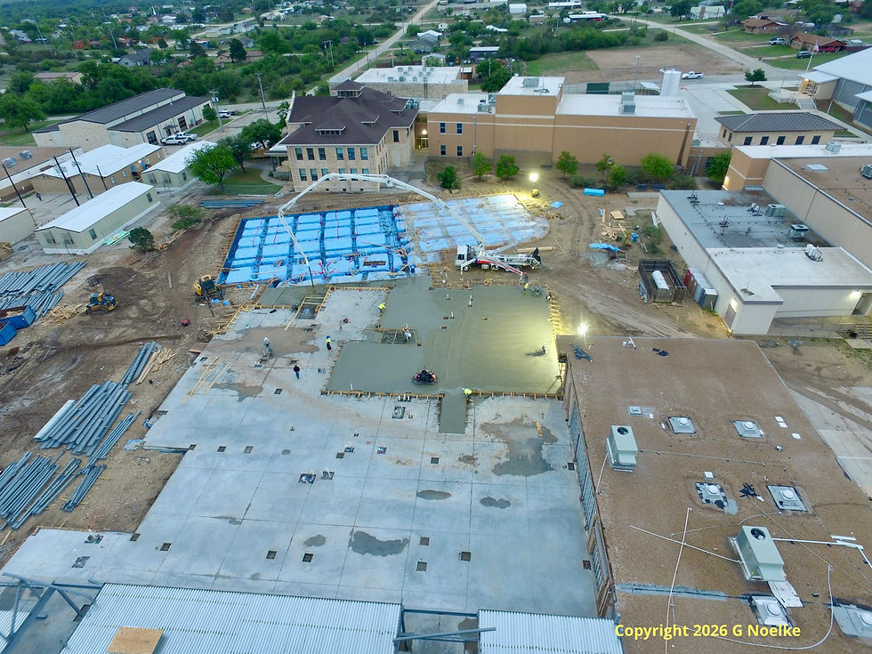 The IC ISD campus on April 22, 2026. The remaining blue foundation will become the new gymnasium, if I remember the plans correctly. The construction is moving along quickly; I hear cement trucks traveling to and from throughout the night.
