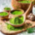 Green powder of herb in the multiple of dishware spoon and bowl and mug.jpg