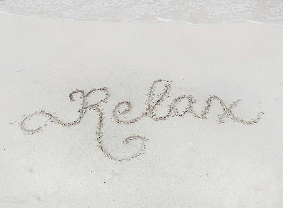 The word relax is inscribed in the sand