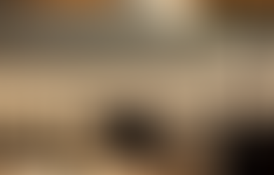 Outdoor restaurant table setting overlooking a lake and mountain range view.