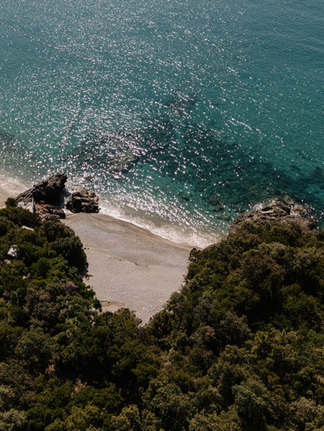 Aerial view of a secluded beach with clear water and coastline