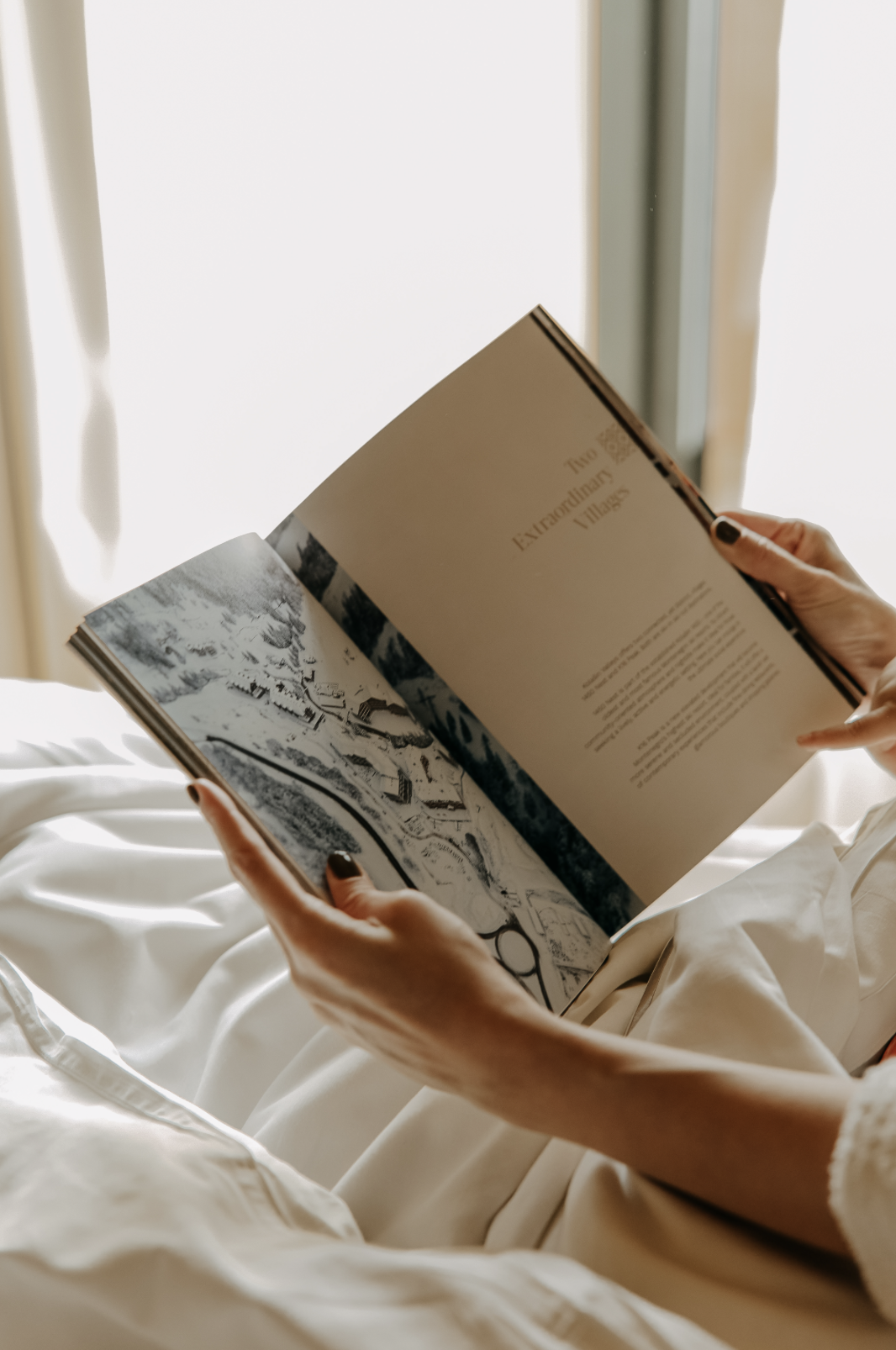 Woman's hands holding open book with text,