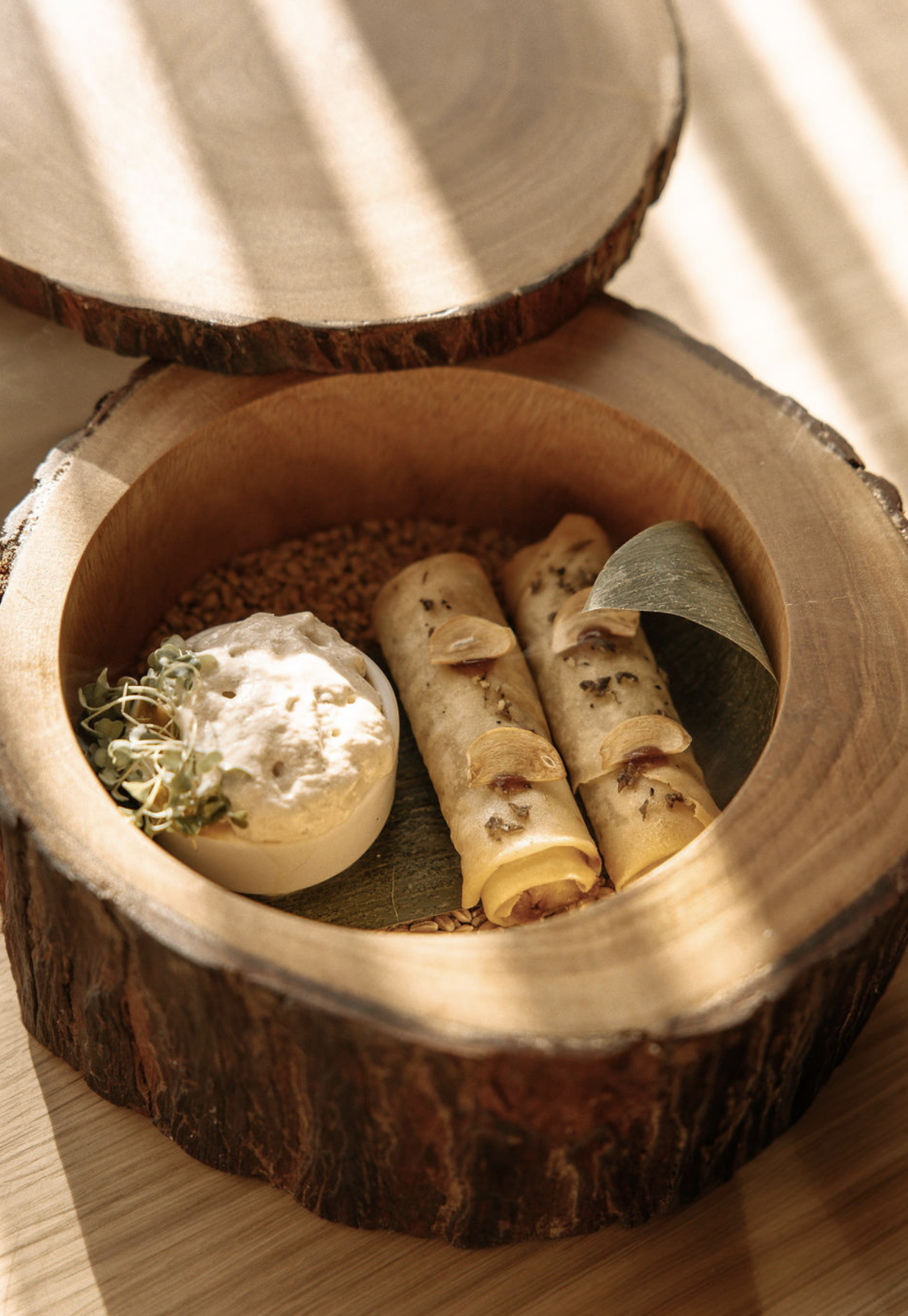 Rolled food with sauce in a wooden bowl for a restaurant meal