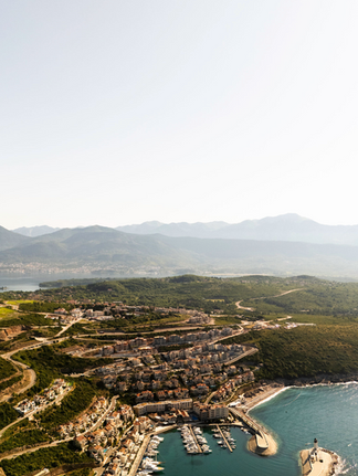 Aerial view of Lustica Bay with mountains in the background and sea