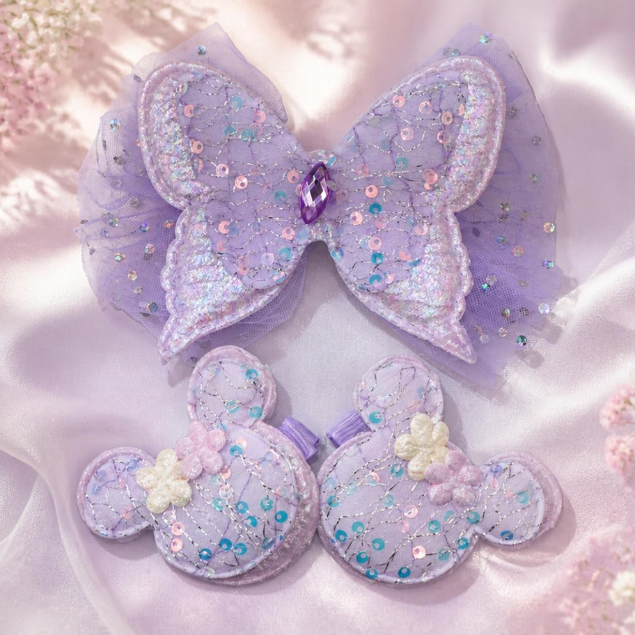 Girls sparkly butterfly hair clip held in a hand, sequin tulle princess hair accessory