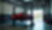 Eye-level view of a hydraulic lift raising a car in a garage
