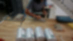 Person assembling battery components on workbench