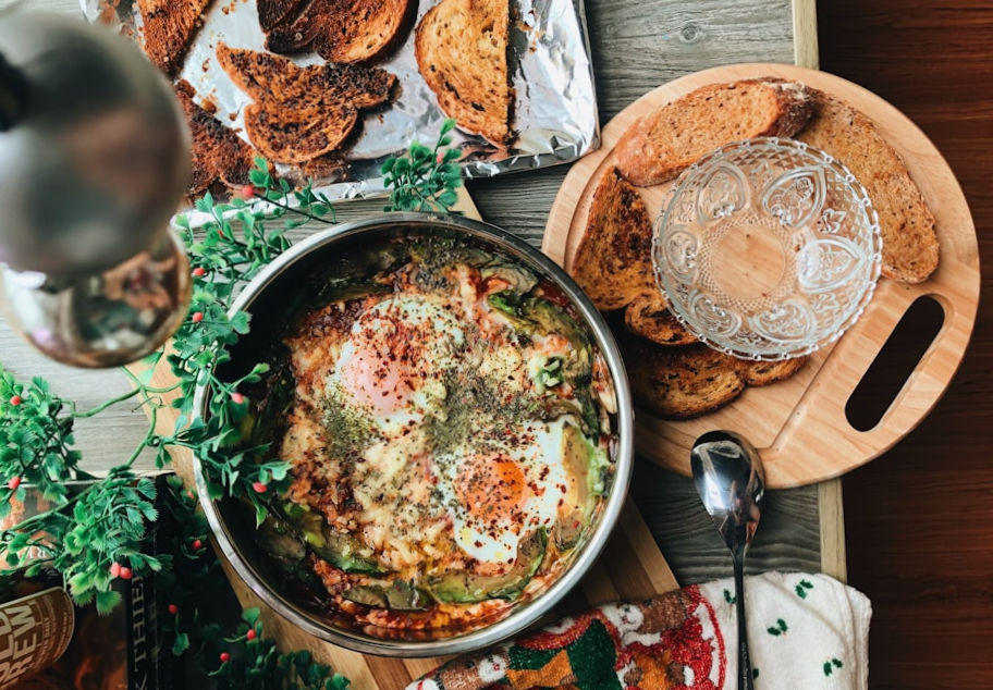 A vibrant, modern baked egg and avocado dish served with toast at a glatt kosher shiva gathering.