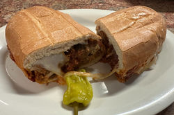 Italian meatball sandwich with marinara sauce and melted mozzarella on a toasted roll