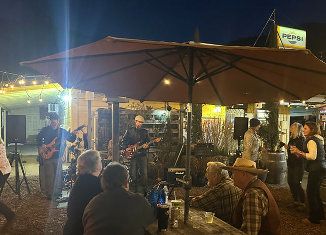 Live music performance on the outdoor patio at Tollhouse Market and Grill