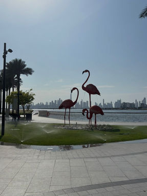 Flamingo sculptures at Dubai Creek Harbour with Downtown Dubai skyline in the background