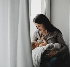 mother-holds-newborn-boy-her-arms-while-she-feeds-him.jpg