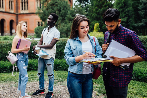 three-students-talking-each-other-outdoor-college-courtyard.jpg