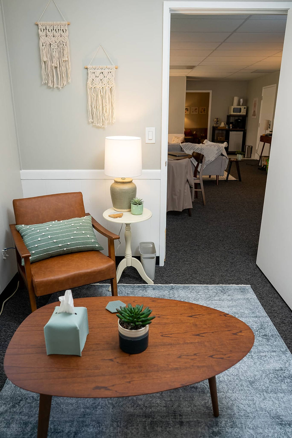 A tranquil zen office featuring a cozy chair and a view of the reception area, highlighting the sere
