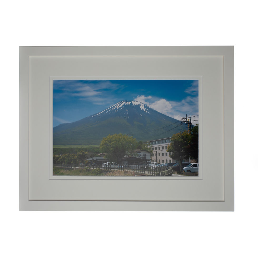 A print of Mt Fuji from lake Tamanaka in a white frame