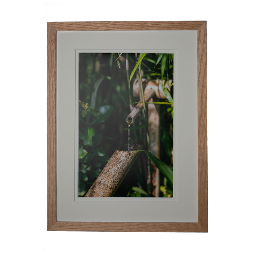 A artistic portrait print of a bamboo water tape in an oak frame