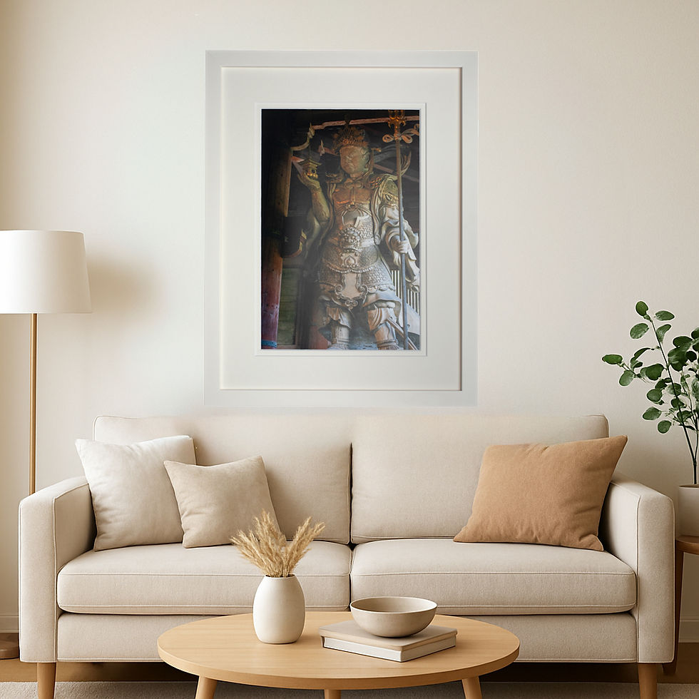 A white framed print of a statue of a Japanese warrior displayed in a living room