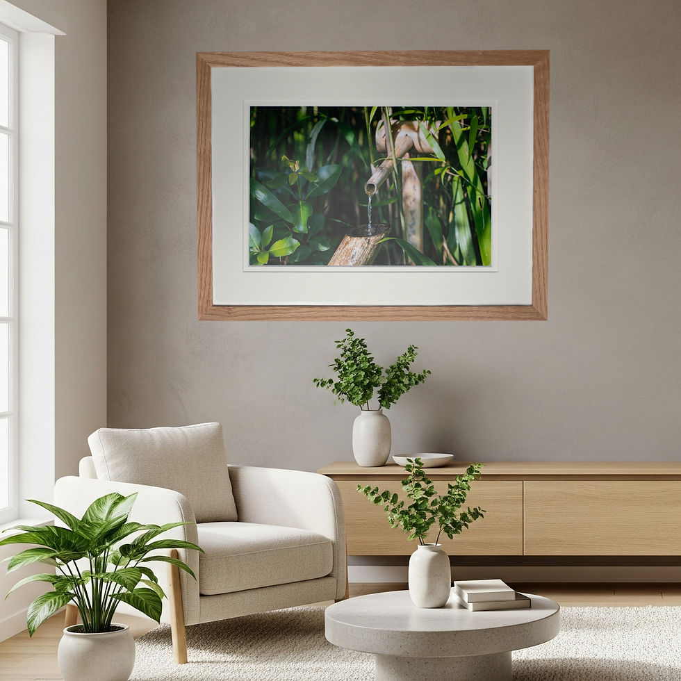 An artistic print of a bamboo water tape in an oak frame hanging in a living room