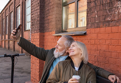 medium-shot-senior-couple-taking-selfie-bench.jpg