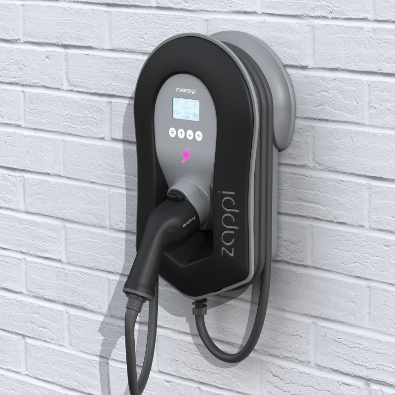 A Zappi EV charger showing its digital display in a modern garage setting.