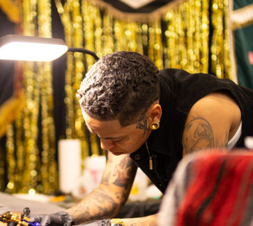 Tattoo artist working at the Grand Rapids Tattoo Festival in Grand Rapids, Michigan